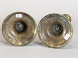pair of antique brass candlesticks on a white background