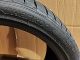 a close up of a tire on a cardboard box with a cardboard box in the background