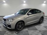 the bmw x4 is parked on a checkered tile floor
