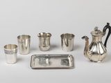 an assortment of silverware including a teapot, cups, tray, and tray