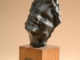 bronze bust of a man on a wooden base