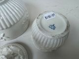 two white vases sitting on a table with a price tag