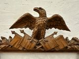 a carved eagle that is sitting on top of a shelf
