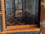 a cabinet that has a clock on top of it