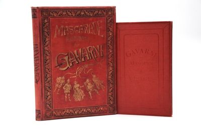 un vieux livre à la couverture rouge posé sur une surface blanche