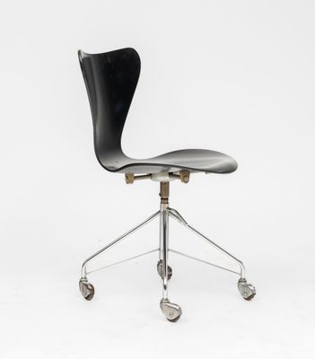a black office chair with wheels on a white background