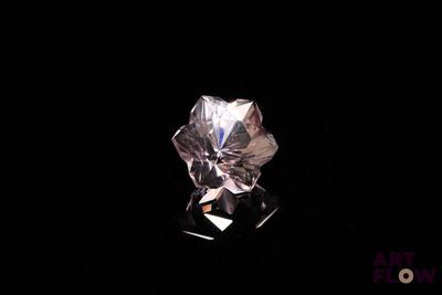 a close up of a diamond on a black surface