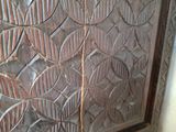 a close up of a wooden cabinet with a glass door