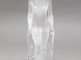 crystal figurine of a woman standing on a clear base