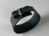 un bracelet en cuir noir orné d'une boucle en argent