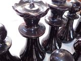 a lot of black chess pieces on a white table