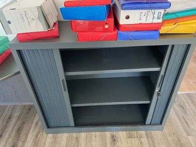 a cabinet with many boxes on top of it
