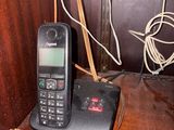 a cell phone sitting on top of a wooden table