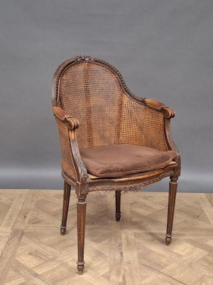 an image of a wicker chair sitting on top of a hard wood floor