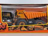 yellow and orange toy dump truck in box with instructions on it