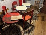 a table and chairs in a room with wood floors