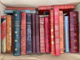 a box full of old books sitting on a table