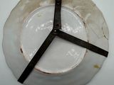 a white plate with a clock on it on a table