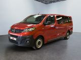 the red van is parked in a large room with a black floor
