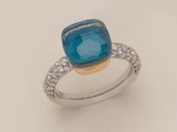a close up of a ring with a blue stone surrounded by diamonds