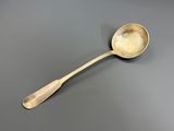 a close up of a spoon on a table with a gray background