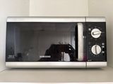 a microwave that has a horse in it on top of a shelf
