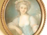 un tableau représentant une femme en robe bleue accroché au mur