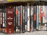 a lot of dvd ' s on the shelf in the room