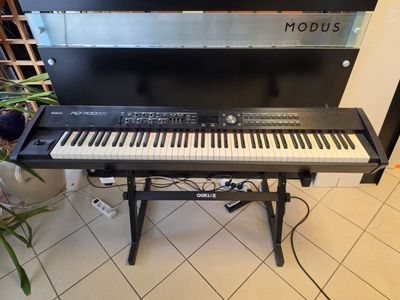 a keyboard that is sitting on a stand in a room