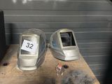 two old computer monitors sitting on a table in front of a wall