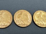 three gold coins, one of which has a head and one of which is a head
