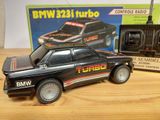 a toy car that is sitting on a table next to a radio