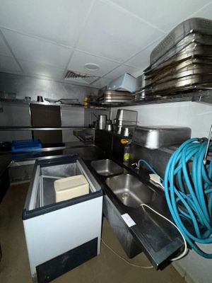 a kitchen with a sink and a lot of pots and pans