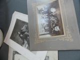 many old photos of people sitting on a table