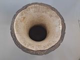a vase that has a hole in the middle of it
