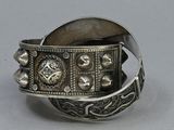 an old silver bracelet with a cross and a cross on it