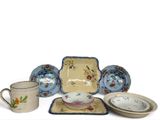 many different types of dishes and cups on the table