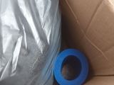 a roll of blue tape in a box with a roll of blue tape in it