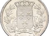 a close up of a coin with a crown on top of it