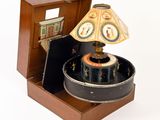 a small wooden box with a lamp inside of it