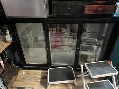 two stools that are sitting in front of a refrigerator