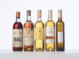several bottles of wine are lined up on a table