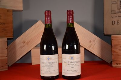 two bottles of wine sitting next to each other on a table