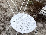 a white chair that is sitting in the dirt