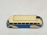 an old toy bus is sitting on a white surface