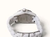 a close up of a watch on a white surface