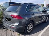 a gray volkswagen suv parked in a parking lot