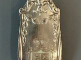 a silver spoon with a picture of a castle on it