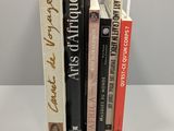 several books are stacked on top of each other on a table