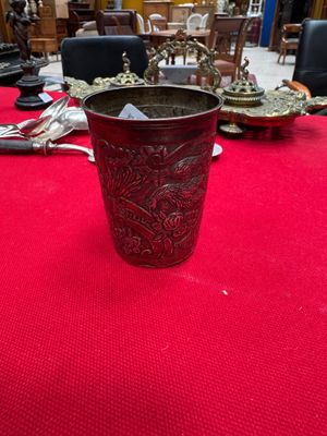 a red table with silverware on it and silverware on the table